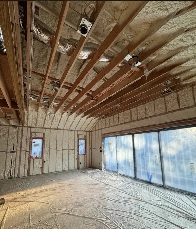 Interior walls and ceiling insulated with spray foam during new construction in Olivarez